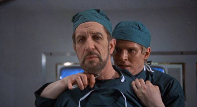 Dr. David Sorel (Christopher Matthews) proposes radical surgery on Dr. Browning (Vincent Price) in Gordon Hessler's Scream and Scream Again (1970)