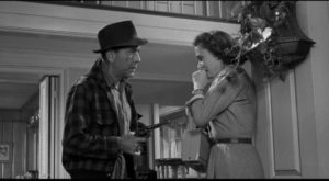 Escaped con Glenn Griffin (Humphrey Bogart) menaces suburban housewife Ellie Hilliard (Martha Scott) in William Wyler's The Desperate Hours (1955)