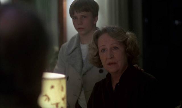Mrs. Nyman (Birgitta Valberg) and her son Stefan (Harald Hamrell) learn unpleasant facts about their murdered husband and father in Bo Widerberg's Man on the Roof (1976)