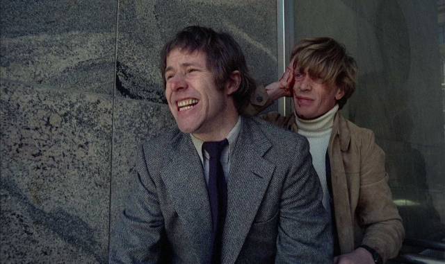 Detectives Lennart Kollberg (Sven Wollter) and Gunvald Larsson (Thomas Hellberg) are pinned down by sniper fire in Bo Widerberg's Man on the Roof (1976)