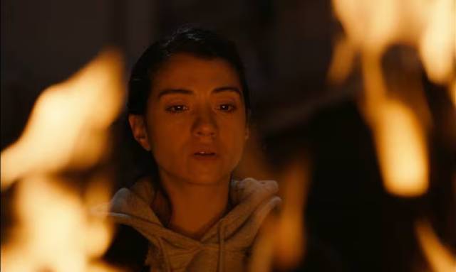 Fatma (Fatma Oussaifi) herself is drawn towards the flames in Youssef Chebbi’s Ashkal: The Tunisian Investigation (2022)