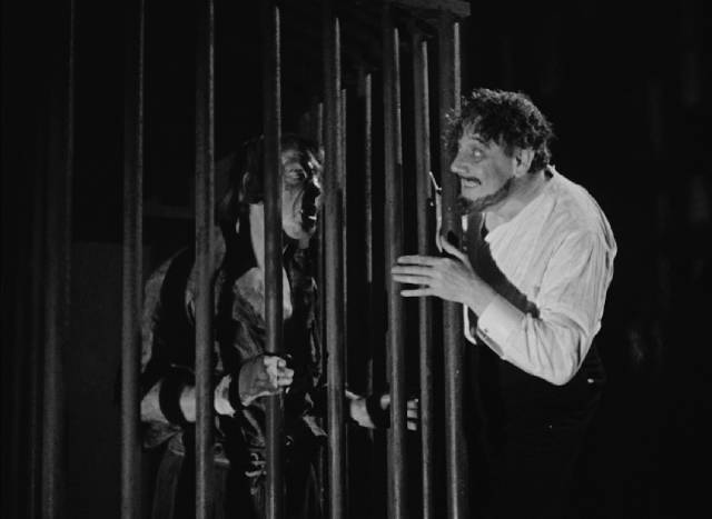 Chevalier Lucio del Gardo (Tod Slaughter) taunts his deformed step-brother (Harry Terry) in George King's The Face at the Window (1939)