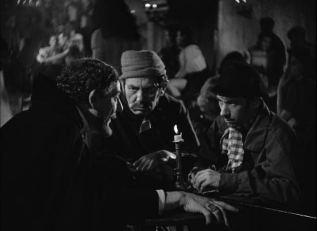 Chevalier Lucio del Gardo (Tod Slaughter) makes plans in the disreputable Blind Rat in George King's The Face at the Window (1939)