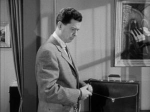 It's agent Bill Winters (Arthur Franz)'s job to carry the briefcase in World of Giants (1959)