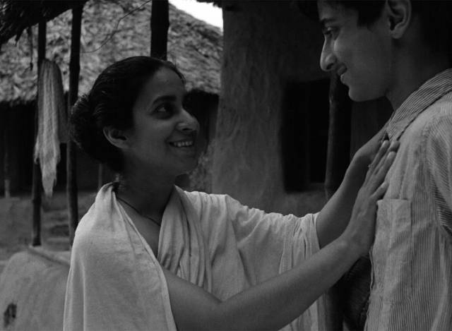 Apu Smaran Ghosal) makes a rare trip home to see Sarbojaya (Karuna Bannerjee) in Satyajit Ray's Aparajito (1956)