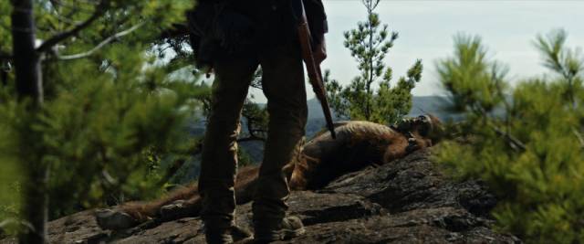 Calvin Barr (Sam Elliott) plugs the disease-carrying Bigfoot in the Canadian forest in Robert D. Krzykowski’s The Man Who Killed Hitler and Then the Bigfoot (2018)