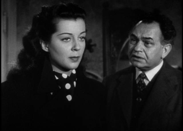 Jean (Gail Russell) believes Triton (Edward G. Robinson)'s warnings in John Farrow's Night Has a Thousand Eyes (1948)