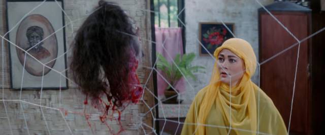 Katemi (Suzzanna) is tormented by supernatural manifestations in Sisworo Gautama Putra's Santet (1988)