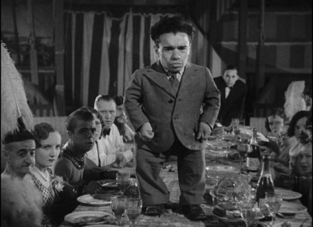 Angeleno (Angelo Rossitto) realizes that Cleopatra (Olga Baclanova) isn't happy about being made an honorary member of the community in Tod Browning's Freaks (1932)