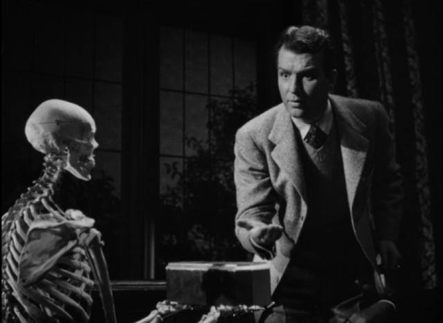 A jewel-bearing skeleton materializes in front of mystery writer Dick Baldwin (Don Porter) in Ford Beebe's Night Monster (1942)