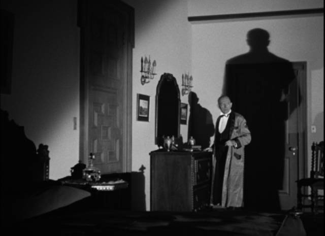 Dr. Timmons (Frank Reicher) is visited by the supernatural assassin in Ford Beebe's Night Monster (1942)