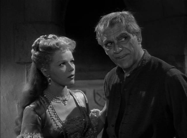 Servant Voltan (Boris Karloff) helps Blanche (Sally Forrest) escape the influence of her uncle in Joseph Pevney's The Strange Door (1951)