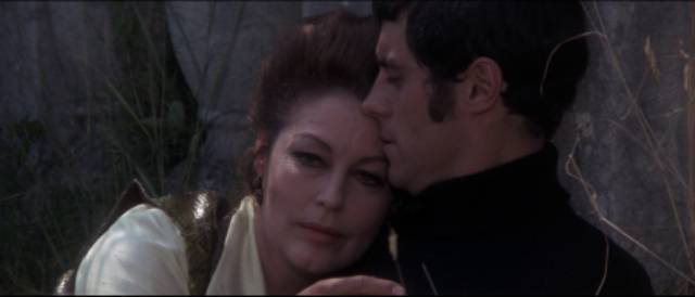 Sensing she's losing her hold, Michaela (Ava Gardner) tries to keep Tom (Ian McShane) close in Roddy McDowall's The Ballad of Tam Lin (1970)