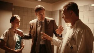 A Swedish lawyer (Alexander Skarsgård) mediates Anna (Tuva Novotny)'s accusation of sexual misconduct against Dr. Helmer (Mikael Persbrandt) in Lars von Trier's The Kingdom: Exodus (2022)