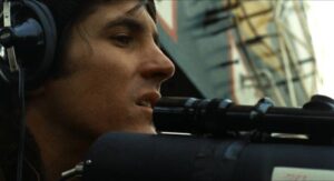 One of Harry Caul (Gene Hackman)'s team uses a sniper-scope to aim his high-powered microphone in Francis Ford Coppola's The Conversation (1974)