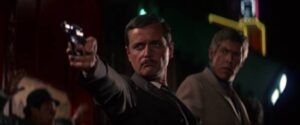 Liberal Wynn Quantrill (William Daniels) gets the drop on federal agents after Dr Sidney Schaeffer (James Coburn) in Theodore J. Flicker’s The President’s Analyst (1967)