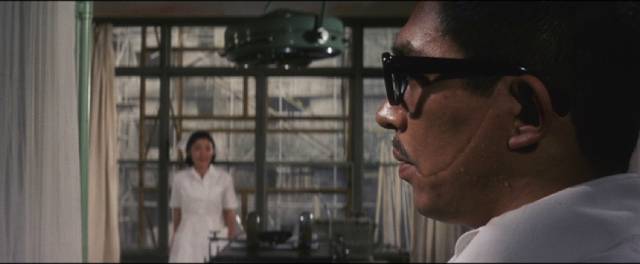 Dr. Amamiya (Noboru Andô) is caught between a troubled past and a troubling present in Tai Katô's By a Man’s Face Shall You Know Him (1966)