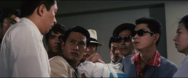 Dr. Amamiya (Noboru Andô) confronts Korean gangsters in Tai Katô's By a Man’s Face Shall You Know Him (1966)