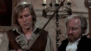 Kronos (Horst Janson) and Professor Grost (John Cater) contemplate the effect of the sword forged from a graveyard cross in Brian Clemens’ Captain Kronos: Vampire Hunter (1974)