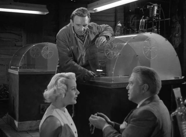 Dr. Harvey (James Hayter) is amazed at the demonstration of what the Replicator can do in Terence Fisher's Four Sided Triangle (1953)