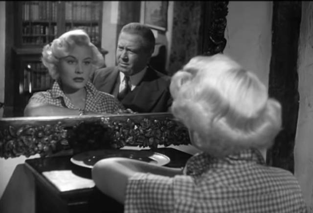 Returning to the village, Lena (Barbara Payton) can't see the point of going on with life in Terence Fisher's Four Sided Triangle (1953)