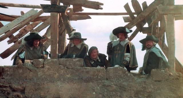 D'Artagnan (Michael York), Athos (Oliver Reed), Porthos (Frank Finlay), Aramis (Richard Chamberlain) and Planchet (Roy Kinnear) join the siege of La Rochelle in Richard Lester's The Four Musketeers (1974)