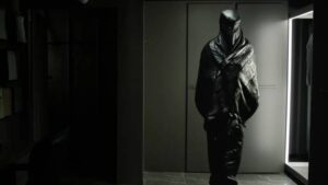Karsh Relikh (Vincent Cassel) tries on one of GraveTech's hi-tech shrouds in David Cronenberg's The Shrouds (2024)