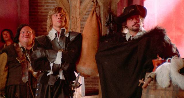 D'Artagnan (Michael York) and Athos (Oliver Reed)use a brawl to conceal the theft of food and wine in an inn in Richard Lester's The Three Musketeers (1973)