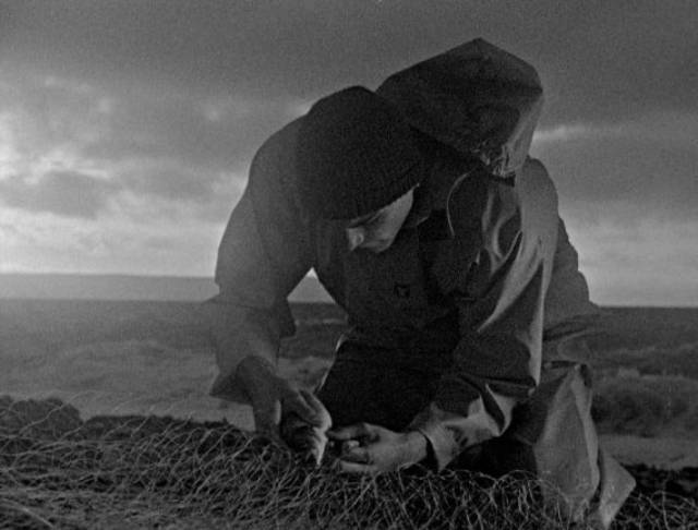 Billy (Martin Ellis) tends Martin's net with painstaking concentration in Mark Jenkin's Bait (2019)