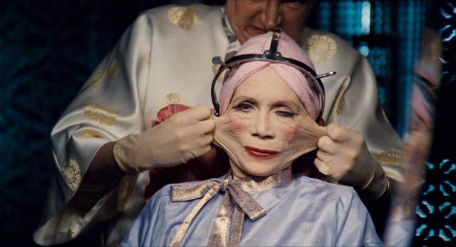 Sam Lowry (Jonathan Pryce)'s mother Ida (Katherine Helmond) gets radical plastic surgery from Dr. Jaffe (Jim Broadbent) in Terry Gilliam's Brazil (1985)
