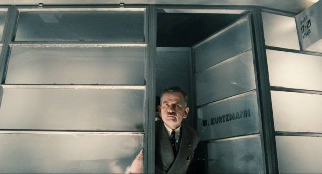 Department manager Mr. Kurtzmann (Ian Holm) relies on Sam Lowry (Jonathan Pryce) to deal with any problems that arise in Terry Gilliam's Brazil (1985)