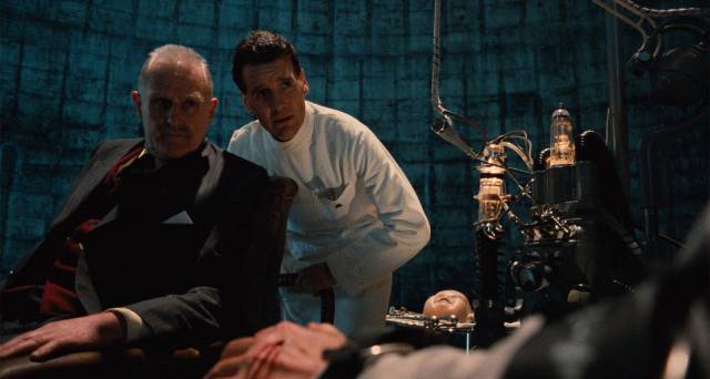Jack Lint (Michael Palin) and Minister of Information Helpmann (Peter Vaughan) realize Sam Lowry (Jonathan Pryce) has retreated into a permanent fantasy in Terry Gilliam's Brazil (1985)