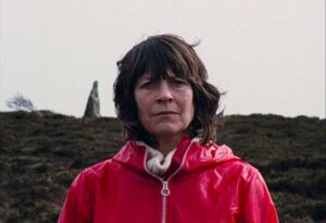 The Volunteer (Mary Woodvine) gradually merges with the island in Mark Jenkin's Enys Men (2022)