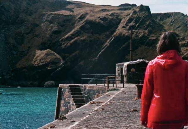 The Volunteer (Mary Woodvine)'s only contact with the world is a weekly supply boat in Mark Jenkin's Enys Men (2022)