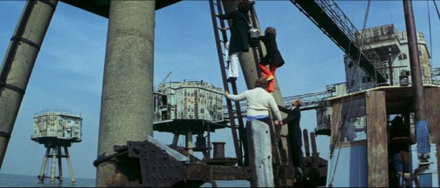 The band visit a pirate radio station for an interview which is interrupted by gunfire in Richard Loncraine's Flame (1975)