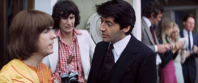 Bassist Paul (Jim Lea) is contemptuous of Robert Seymour (Tom Conti)'s Publicity stunts in Richard Loncraine's Flame (1975)