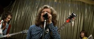Stoker (Noddy Holder) takes over as lead singer of the newly formed band in Richard Loncraine's Flame (1975)