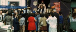 Stoker (Noddy Holder) doesn't expect to succeed and keeps his day job in the local market in Richard Loncraine's Flame (1975)