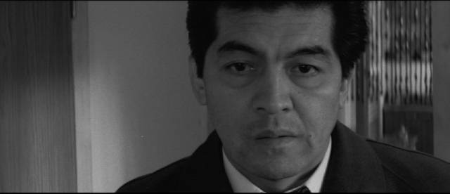 The family of a downtrodden salaryman is held hostage in Kinji Fukasaku's The Threat (1966)
